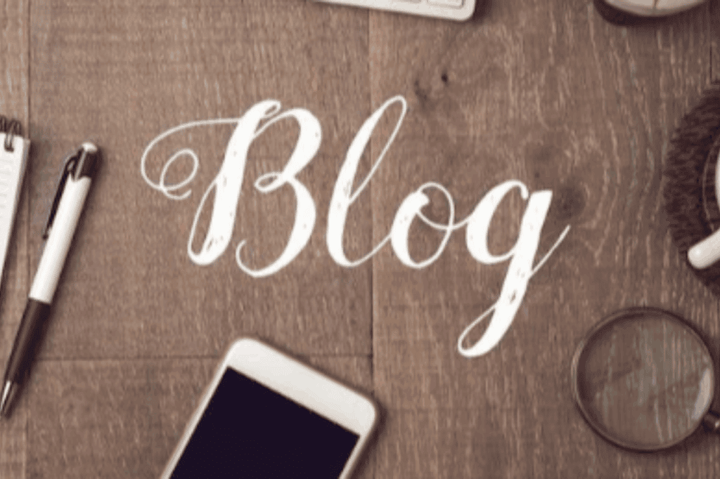 Wooden table with the word 'blog' written in neat joined handwriting.