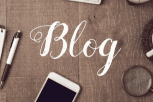 Wooden table with the word 'blog' written in neat joined handwriting.