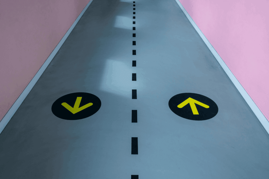 Graphic of single carriageway with arrows pointing in the direction of traffic, symbolising website user experience.