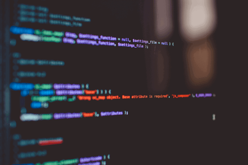 A black computer screen with coloured lines of code to show technical seo