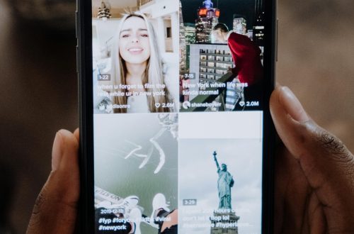 pexels-photo-5081917-5081917 Close-up of a person using a smartphone to browse a social media app indoors.