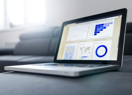 pexels-photo-577210-577210 Sleek laptop showcasing data analytics and graphs on the screen in a bright room.