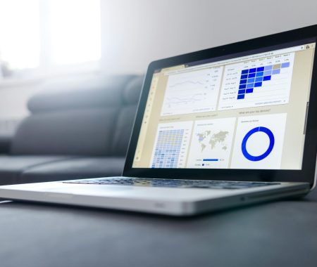 pexels-photo-577210-577210 Sleek laptop showcasing data analytics and graphs on the screen in a bright room.