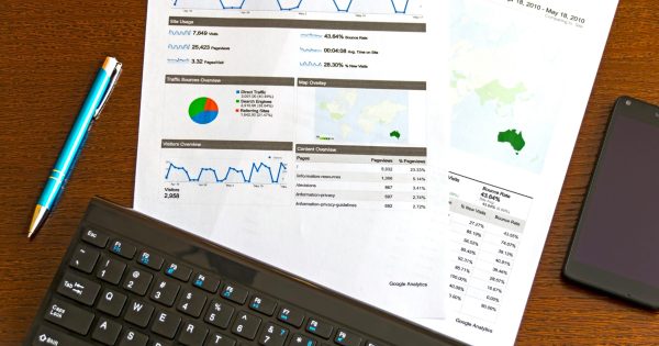pexels-photo-95916-95916 Flatlay of a business analytics report, keyboard, pen, and smartphone on a wooden desk.