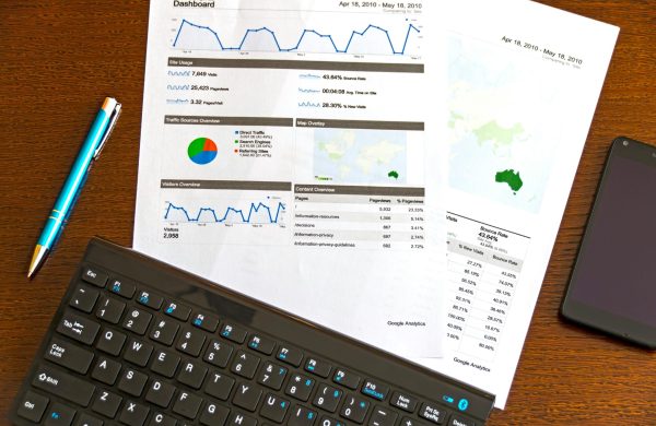pexels-photo-95916-95916 Flatlay of a business analytics report, keyboard, pen, and smartphone on a wooden desk.